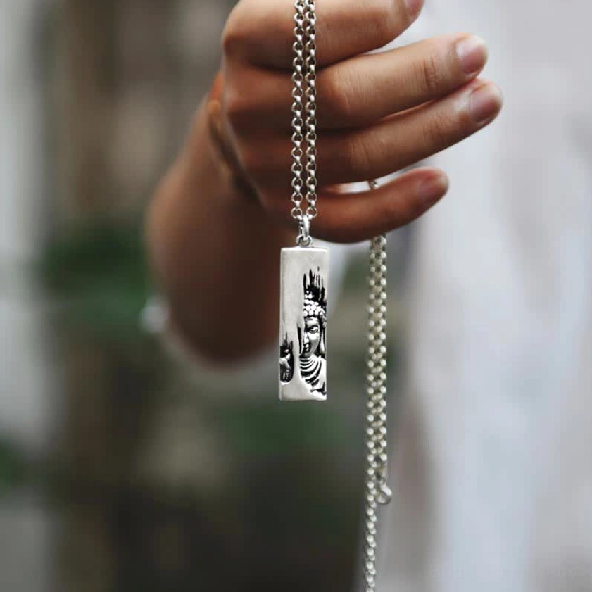 Tathagata Buddha pendant necklace hand-held display - copper Buddha relief on thick metal chain outdoor setting