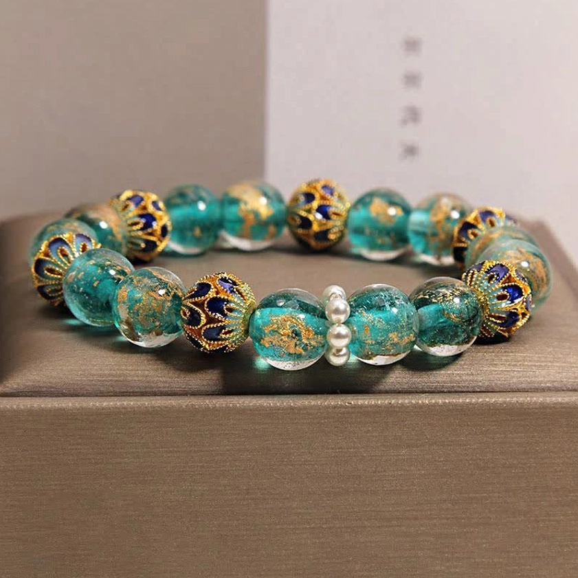 Teal cloisonné glass Buddhist bracelet with blue-gold enamel beads and white pearl spacers close-up