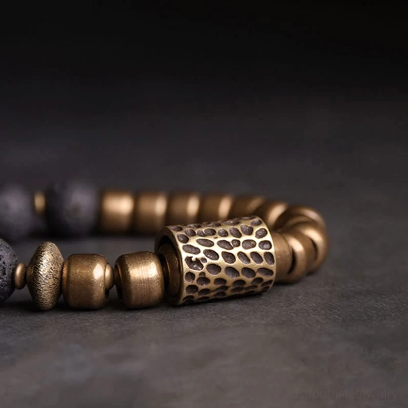 Close-up side profile showing textured brass spacer bead and sequential arrangement of rainbow obsidian and lava rock beads