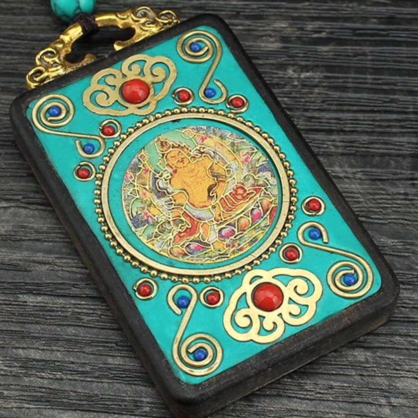 Extreme close-up of Five Gods of Wealth thangka pendant - vibrant enamel red blue gold artwork