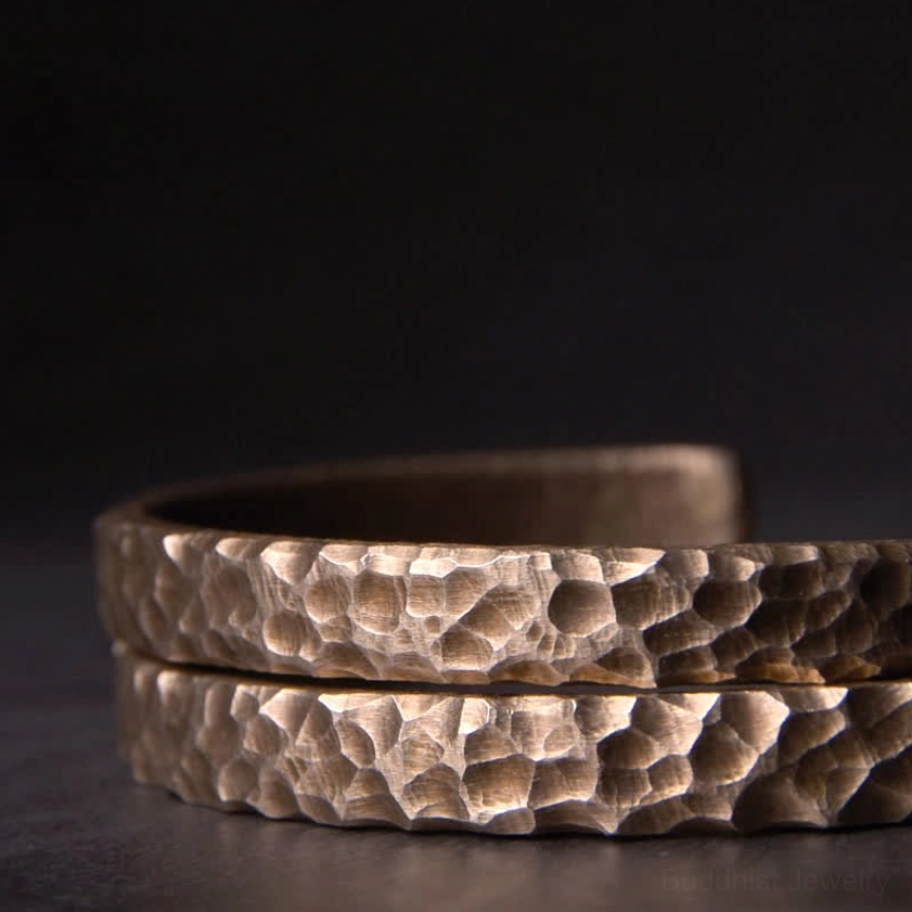 Thick hammered copper open cuff bracelet with bronze finish showing substantial artisanal craftsmanship detail