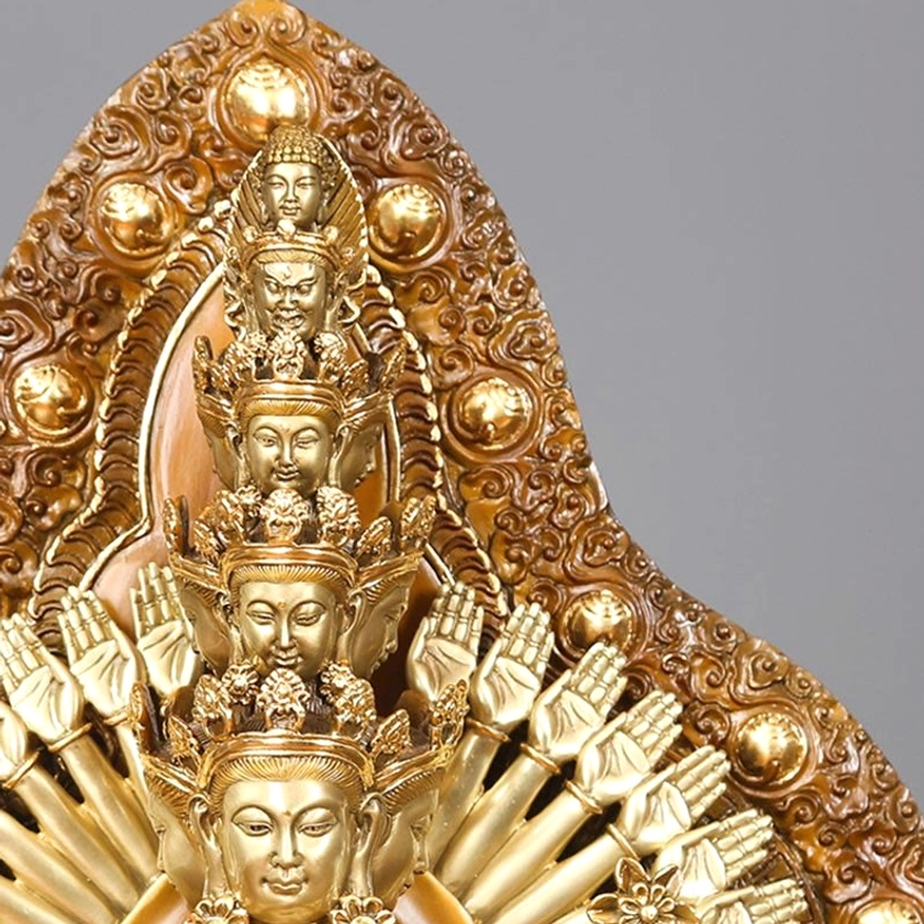 Close-up detail of Avalokitesvara statue crown and backboard showing stacked Buddha heads and ornate carved floral patterns