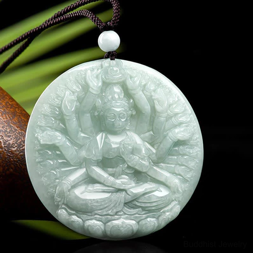 Close-up frontal view of thousand-hand Guan Yin jade pendant highlighting intricate carved relief work, natural light cyan jade stone with black hanging cord