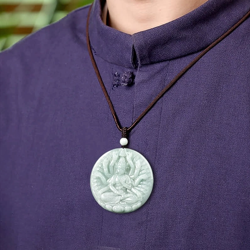 Thousand-hand Avalokitesvara jade necklace worn on person in purple traditional clothing, showing pendant length and wearable styling with brown wax cord
