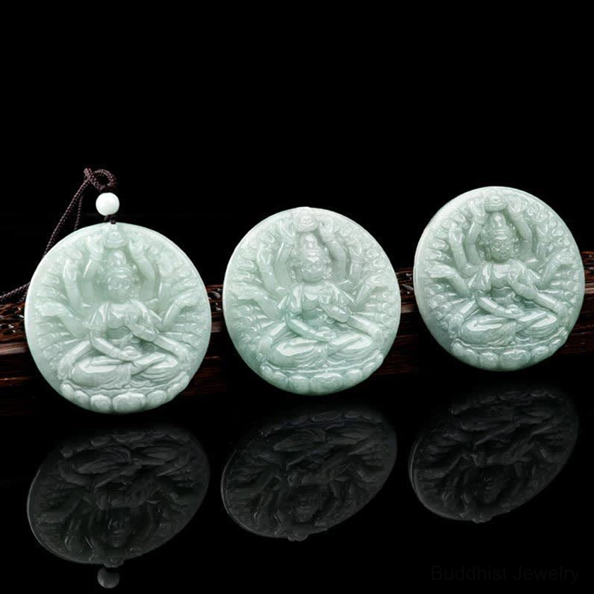 Set of three thousand-hand Avalokitesvara jade pendants in varying sizes displayed on glossy black reflective surface, showing light green natural jade collection