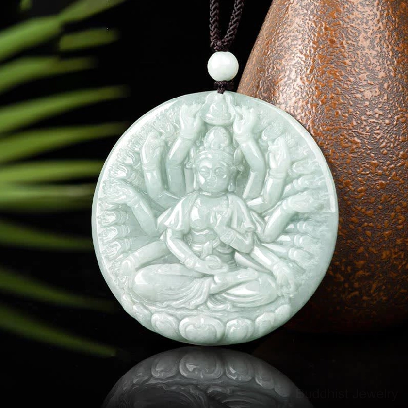Thousand-hand Guanyin jade pendant frontal flat view with artistic brown and green background showing complete carved relief, light cyan jade on black hanging cord
