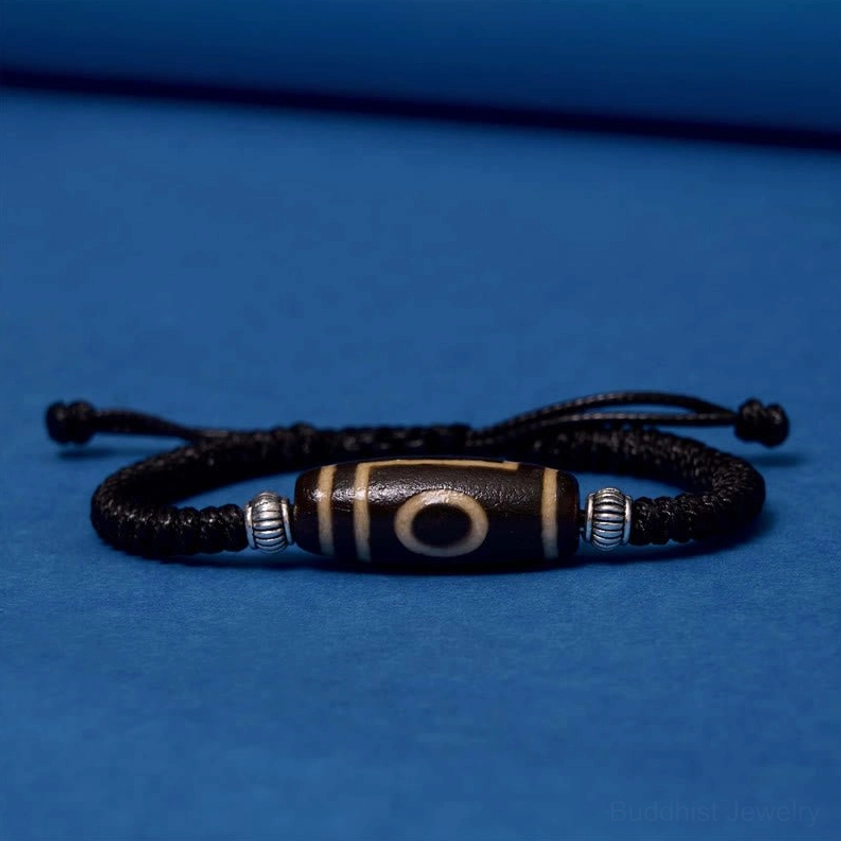Three-eye dzi bead bracelet full circle layout showing complete symmetrical design with metal spacers