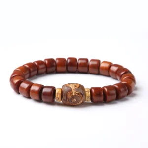 Three-eyed Dzi bone bead bracelet flat lay top view with carved dzi focal bead on white background