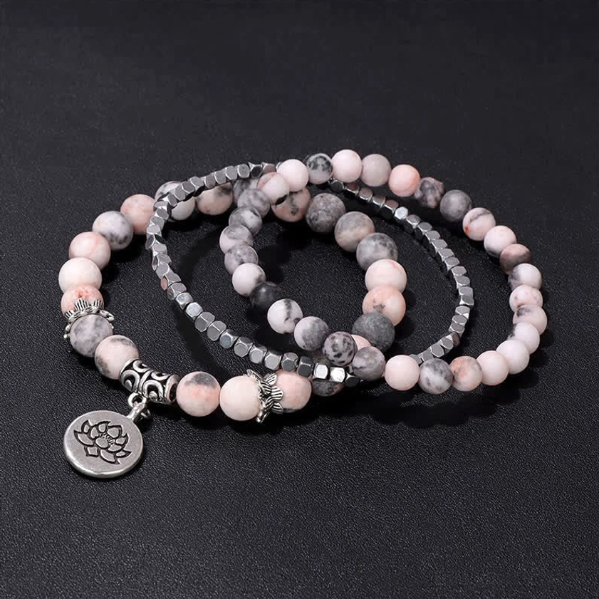 3-piece stacked beaded bracelet set with lotus charms on black backdrop