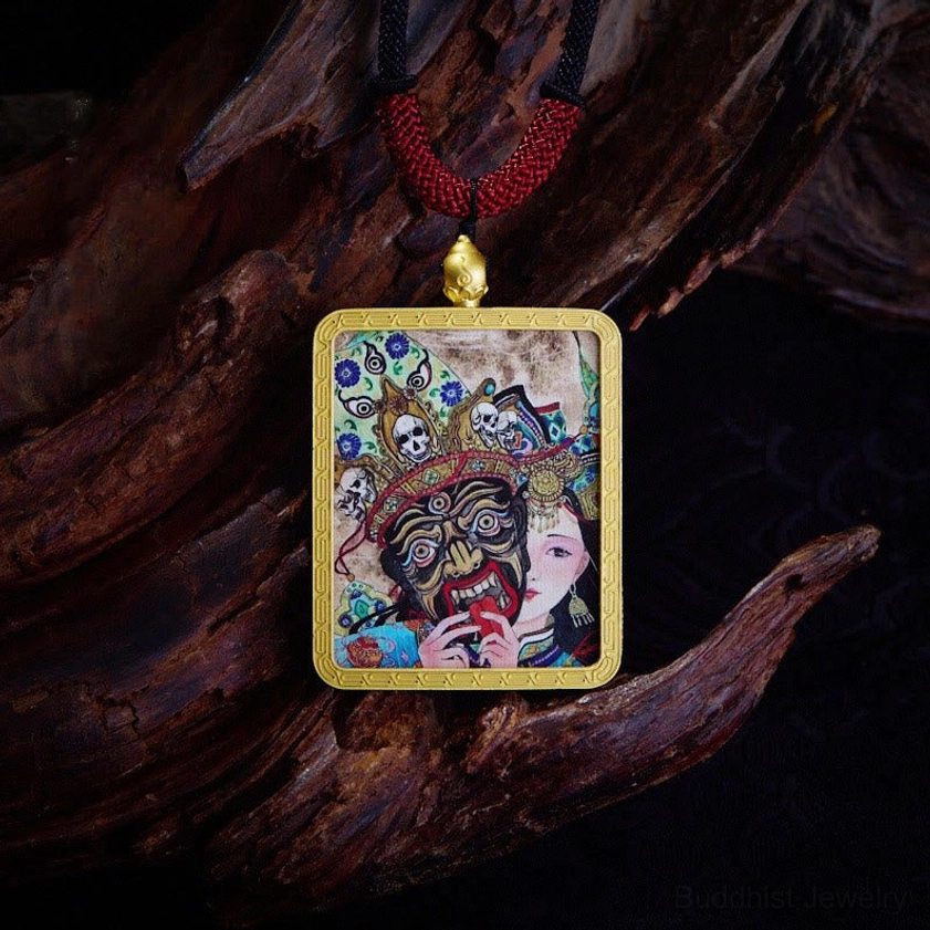Tibetan Buddhist Thangka pendant with fierce deity and goddess figure artwork in gold metal frame with red cord