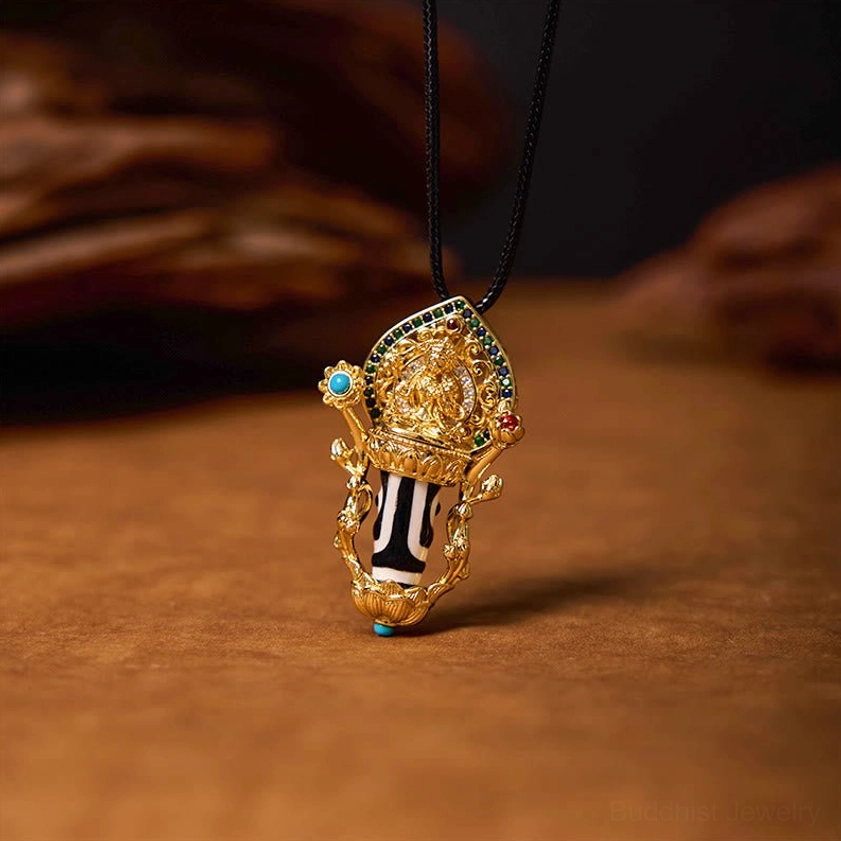 Tibetan Dzi Bead amulet necklace with hand-painted striped Dzi and gilded Buddhist statue mount with blue decorative bottom bead, front view