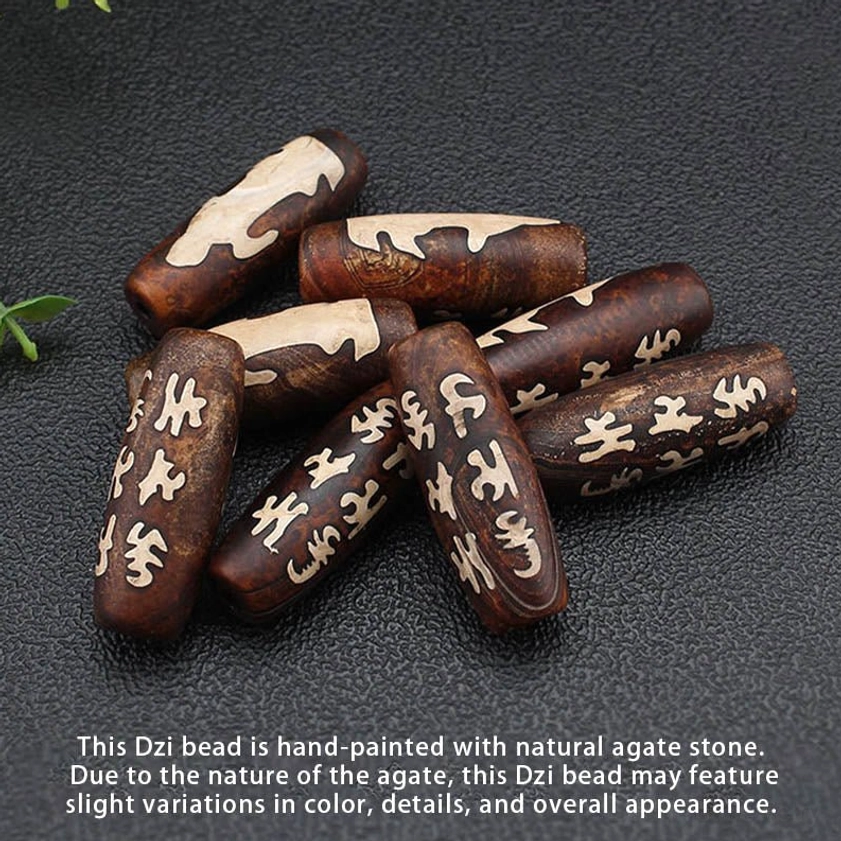 Loose Tibetan Buddhist Dzi beads collection showing various hand-painted agate stone beads with sacred mantras and patterns