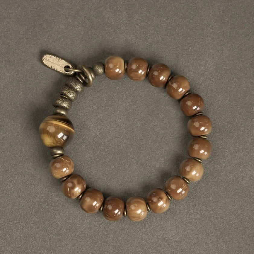 Beaded stretch bracelet with curved brass clasp and tiger eye focal stone