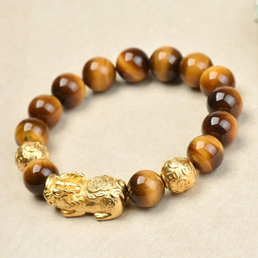 Tiger eye bracelet with engraved metal spacer and Pixiu charm detail