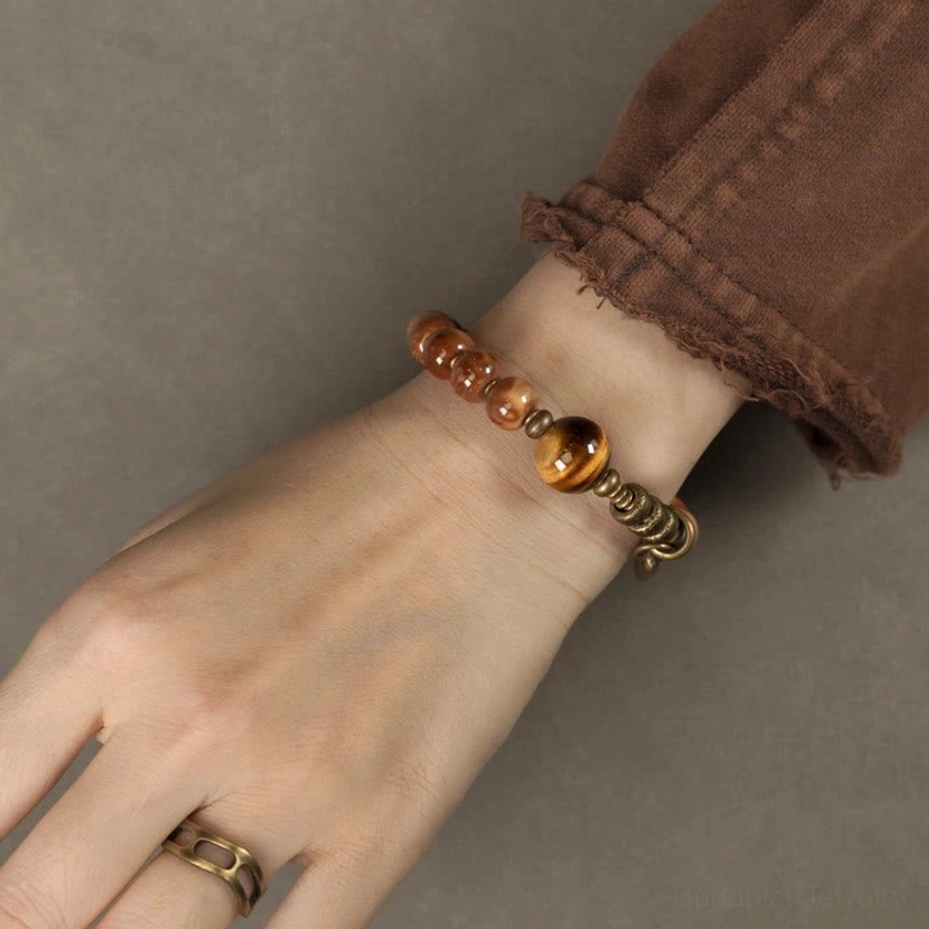 Slim beaded bracelet with tiger eye focal bead worn on hand side view