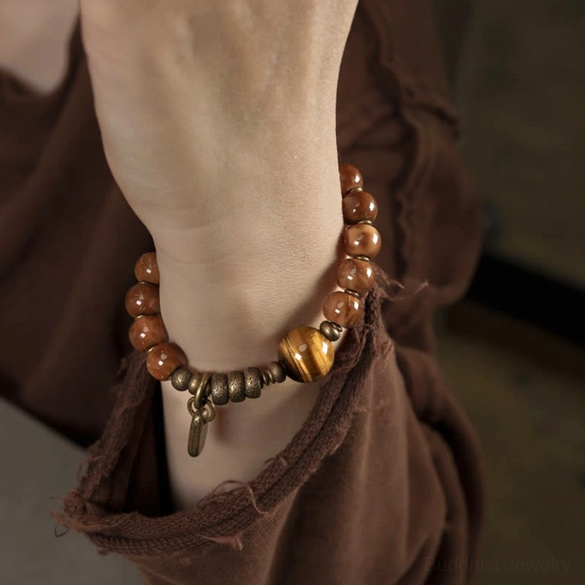 Tiger eye Buddhist prosperity bracelet worn on wrist with vintage styling