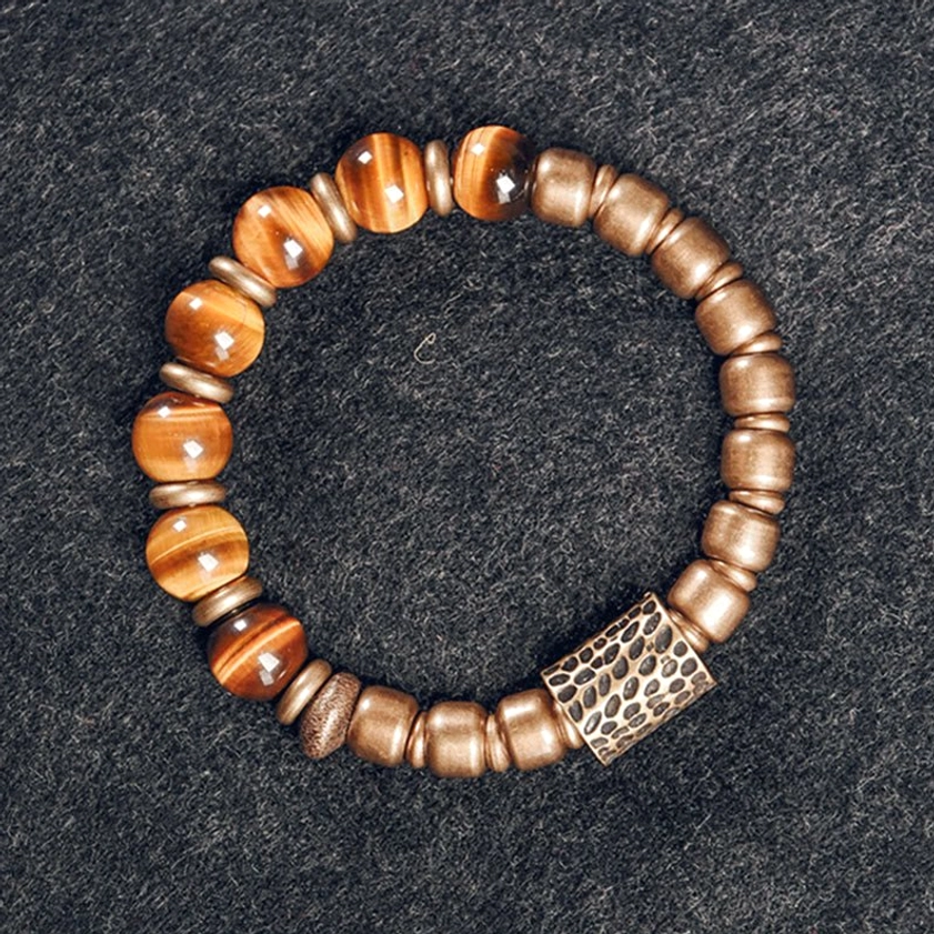 Alternating tiger eye and matte copper beads on premium elastic string, overhead shot on dark grey fabric