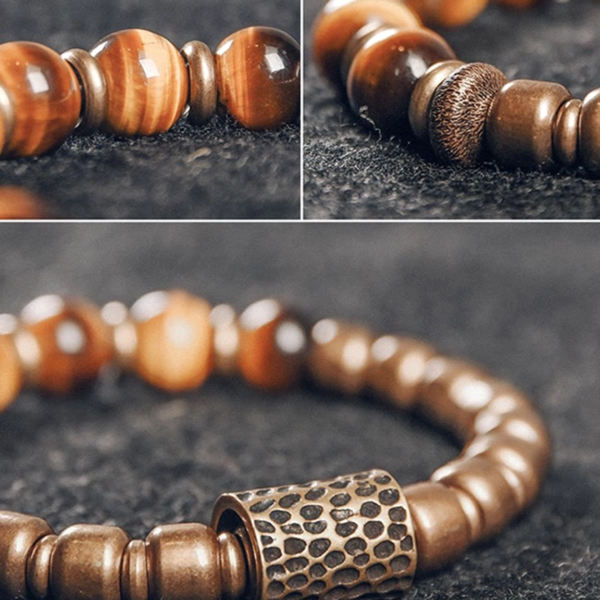 Tiger eye stone bracelet on wrist with adjusted bead spacing, side angle with grey coat cuff visible
