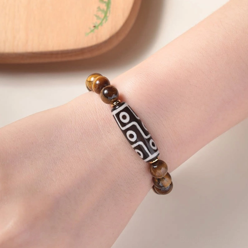 Tiger eye and nine-eye dzi Buddhist bracelet worn on wrist showing real-life fit and color