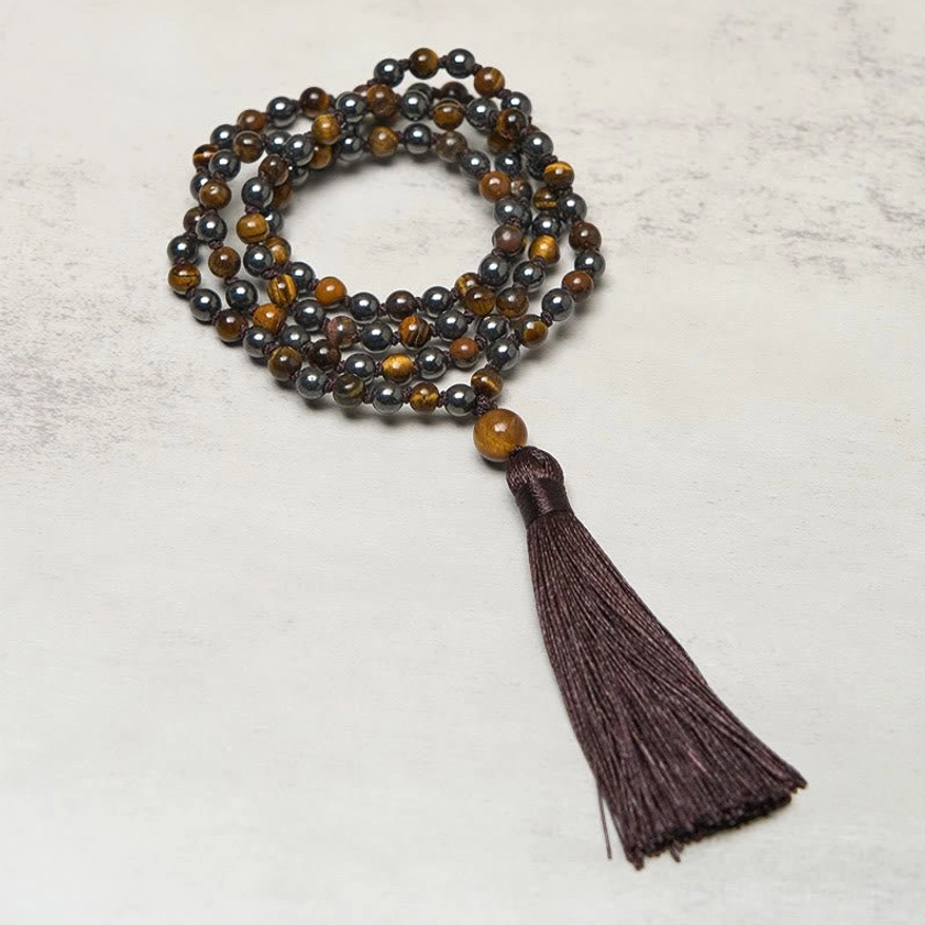 108 bead tiger eye hematite prayer mala necklace close-up overhead view with dark brown tassel