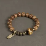 Tiger eye kuka seed Buddhist bracelet with brass accents flat lay display