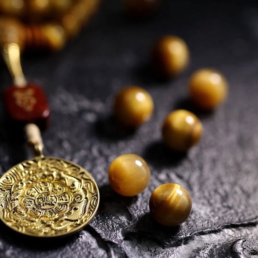 Sacred Tiger Eye prayer mala 108 beads with protective Vajra symbol - lifestyle product shot