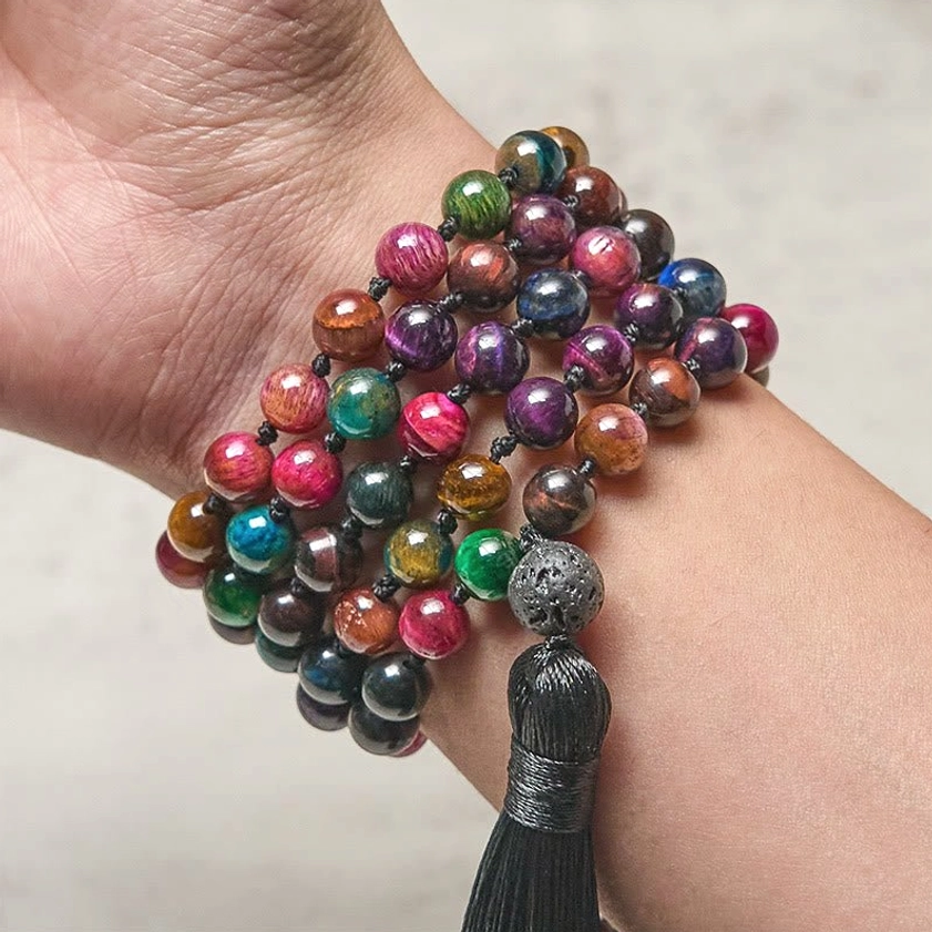Tiger eye mala beads worn on wrist showing multicolor bead details close up