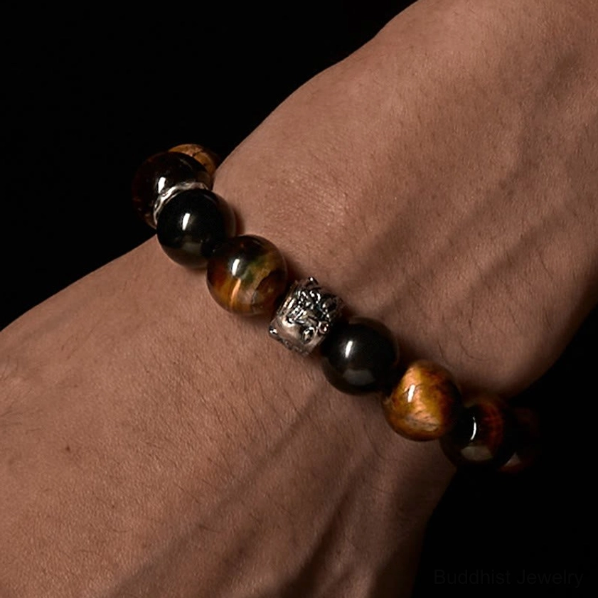 Buddhist protection bracelet worn on wrist showing fit and comfort with mixed brown and black stone beads