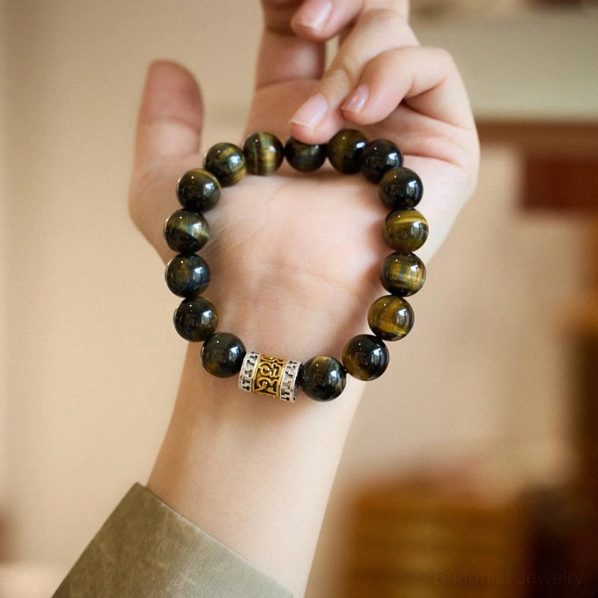 Tiger eye bracelet worn on wrist showing comfortable fit and polished natural stone beads with spiritual mantra charm