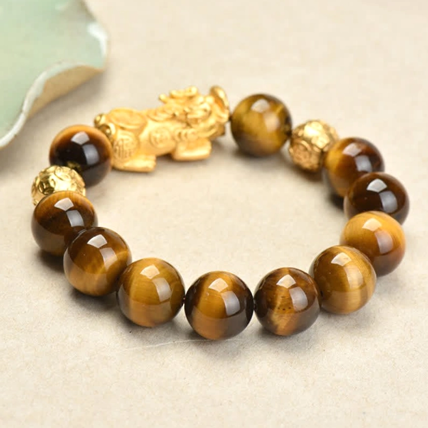 Tiger Eye Pixiu bracelet with multiple copper spacer beads, detailed flat lay