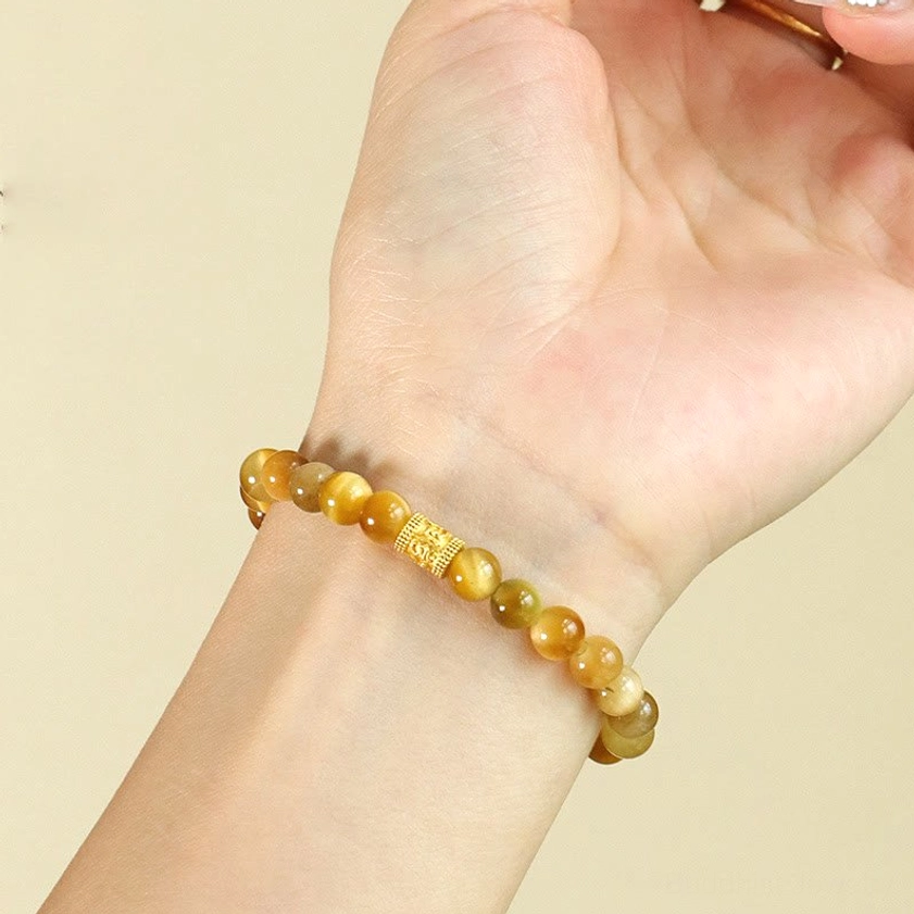 Natural tiger eye stone beads close-up showing golden brown protective gemstone