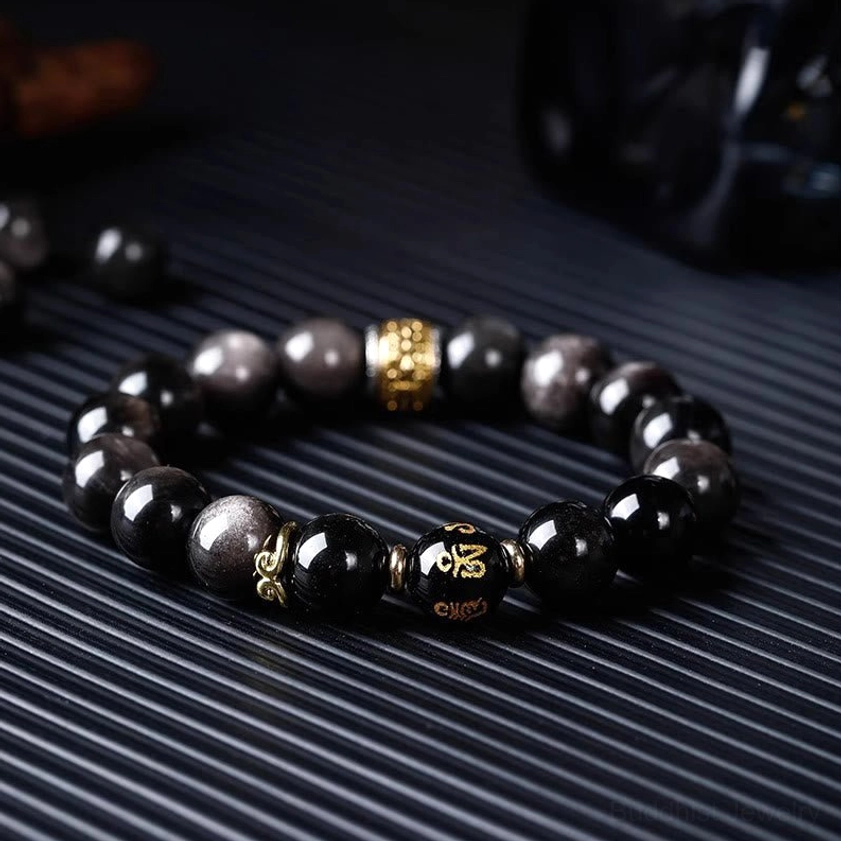 Tigers Eye and Silver Sheen Obsidian dual-stone bracelet with engraved Om Mani Padme Hum charm showing authentic Buddhist spiritual jewelry