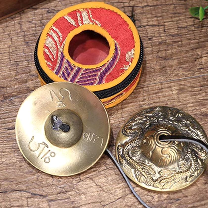 Tingsha bells showing om mani padme hum sacred mantra for spiritual practice and mindfulness