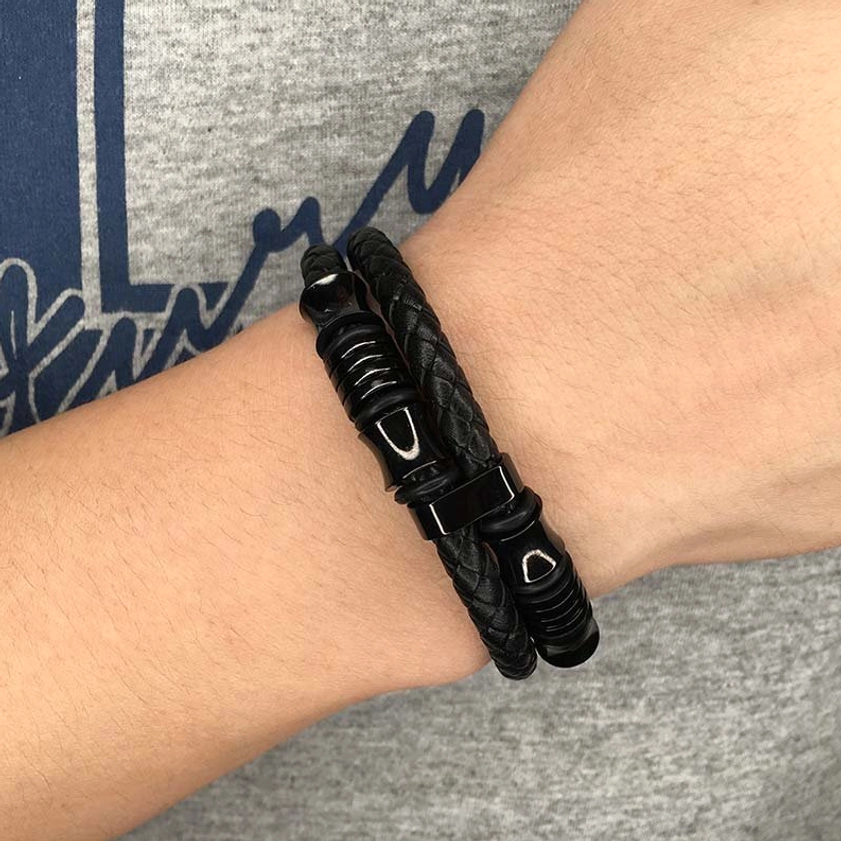 Layered black leather weave bracelet worn on wrist showing double layer design and secure fit