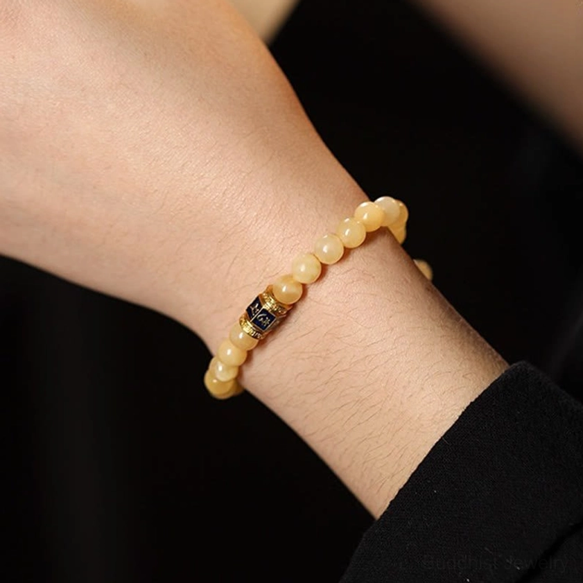 Topaz Om Mani Padme Hum bracelet worn on wrist close-up side profile studio shot