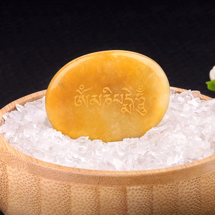 Om Mani Padme Hum topaz palm stone with golden Sanskrit text detail