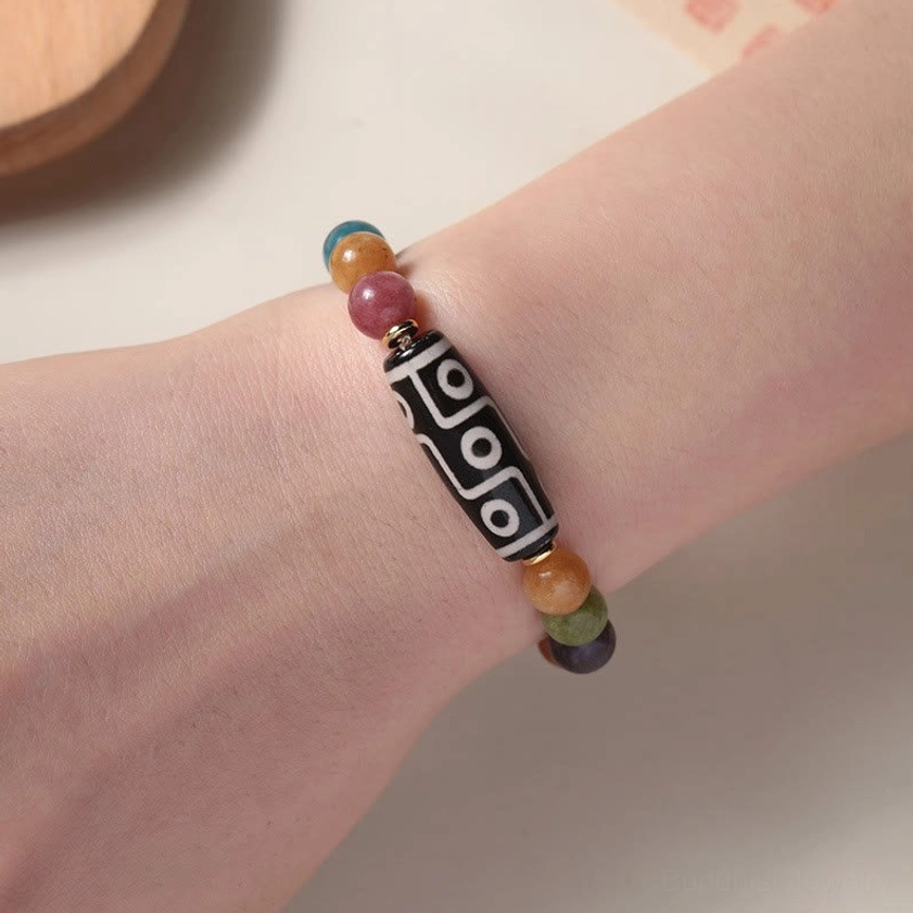 Tourmaline nine-eye dzi Buddhist bracelet worn on wrist displaying vibrant multi-color bead design