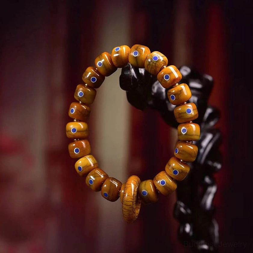 Traditional Buddhist prayer bead bracelet with tan bone beads and lapis lazuli stone details