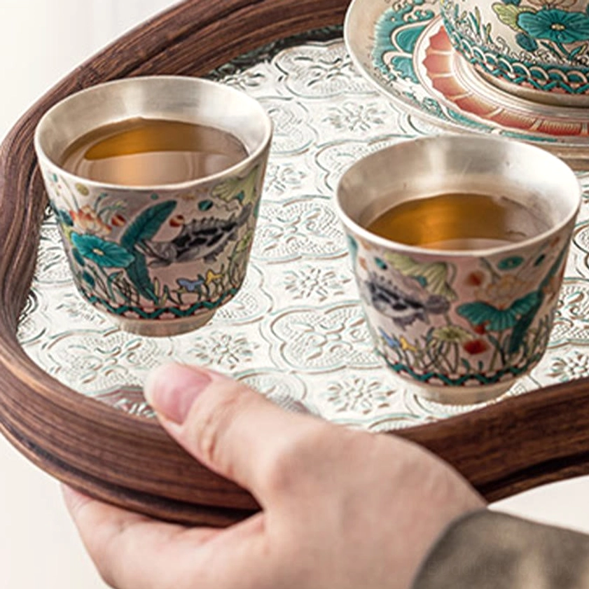 Traditional ceramic teacup with hand-painted aquatic and floral motifs, high-fired craftsmanship