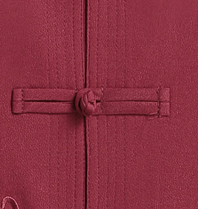 Traditional Chinese frog button close-up - flat lay showing knot-style button detail on maroon fabric with visible placket seams