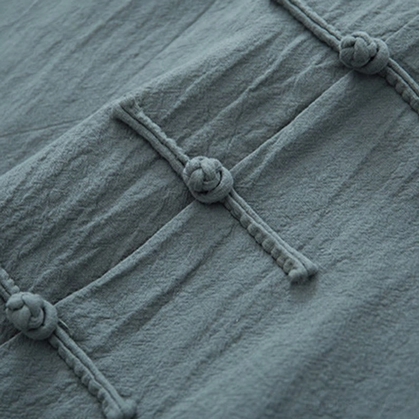 Close-up of traditional chinese frog button knot and linen placket showing handcrafted details of zen tang suit