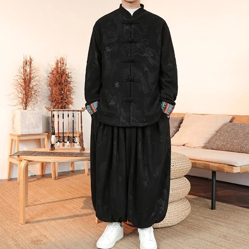 Men's traditional Tang suit two-piece, black jacquard fabric with hands in pockets, displaying frog button design