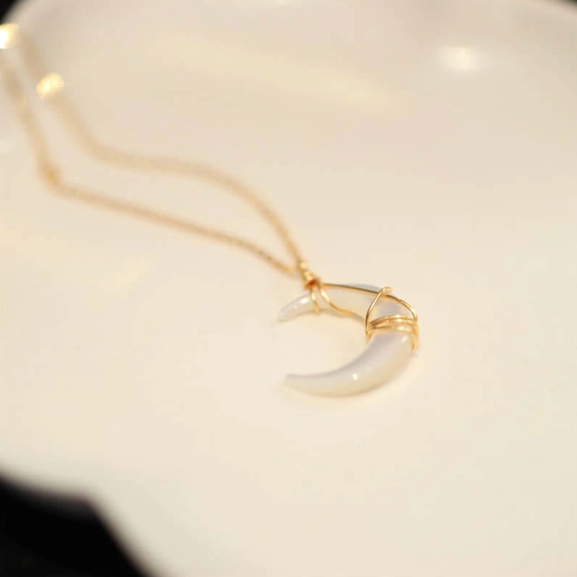 Tridacna crescent moon Buddhist pendant necklace side flat lay position on light surface showing profile and chain attachment point