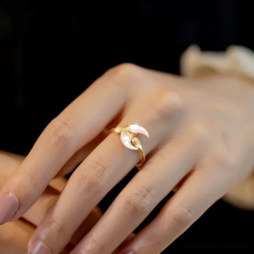Tridacna stone moon blessing ring worn on hand, side view showing adjustable open design and comfortable fit