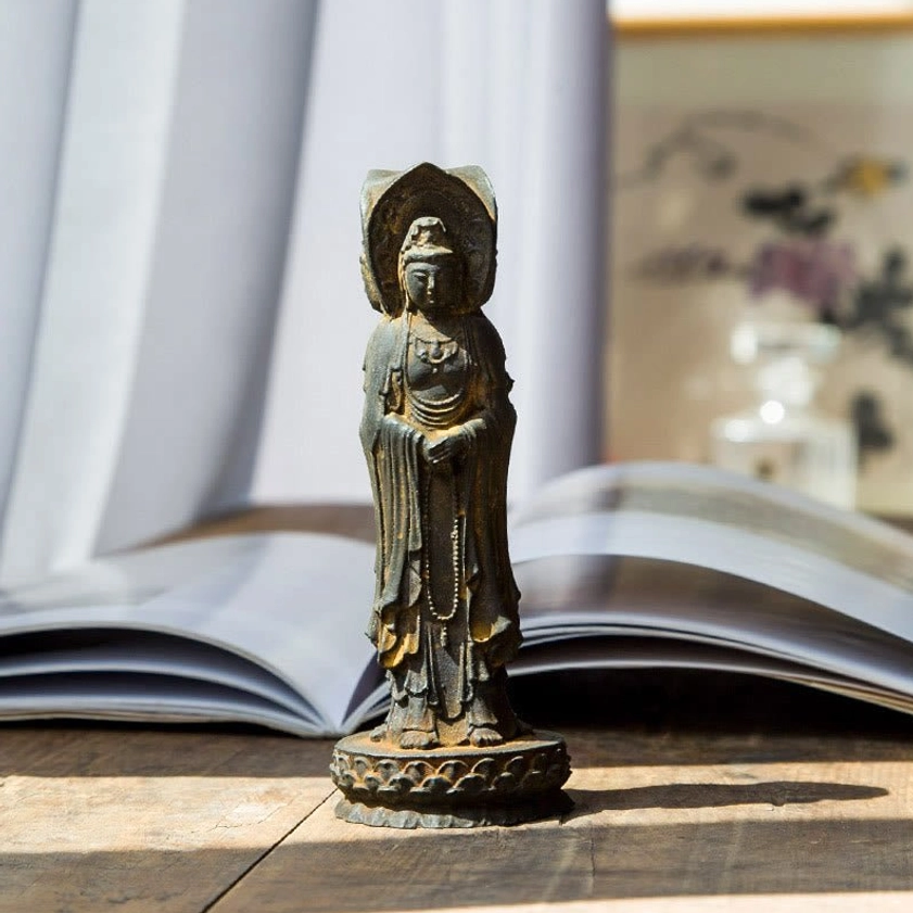 Avalokitesvara three-sided statue showing intricate Buddhist robe details and serene expressions