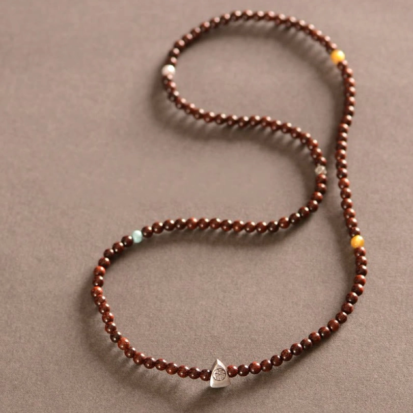 Triple wrap red sandalwood bracelet with engraved Fu pendant for luck and spiritual protection