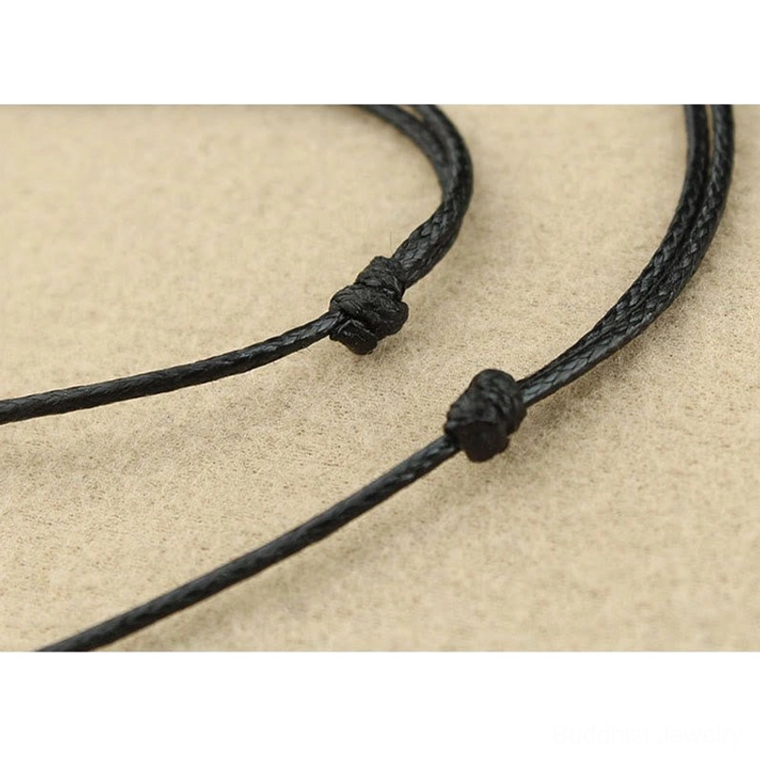 Turquoise Buddhist necklace pendant showing side angle view of three-dimensional marquise shape and craftsmanship