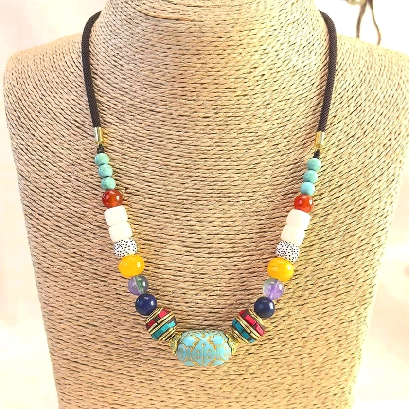 Handmade turquoise beaded necklace worn on mannequin, showcasing chakra balance pendant design and beading pattern
