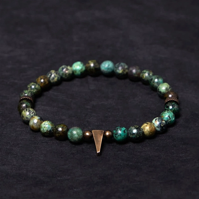Natural turquoise stone beads with polished copper accent spacers on distressed copper spike charm bracelet