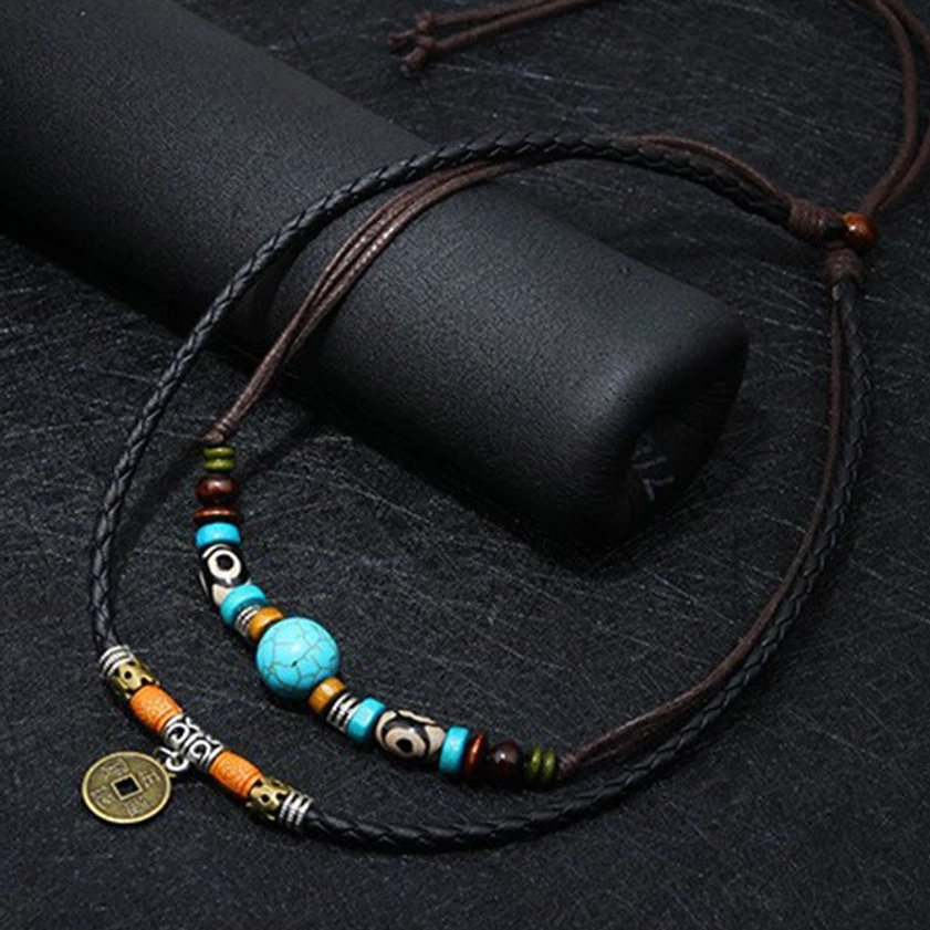 Close-up detailed view of turquoise Dzi bead Buddhist necklace showing sky-blue turquoise stone and patterned beads